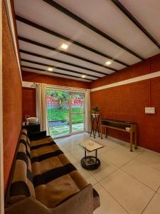 a living room with a couch and a piano at Rockviewstay in Kalpetta