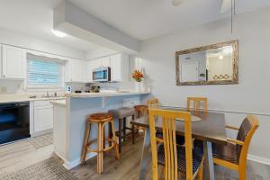 a kitchen and dining room with a table and chairs at Fort Morgan Townhomes E7 in Fort Morgan