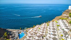 an aerial view of the ocean with a boat at Bahia Blanca in Puerto Rico de Gran Canaria