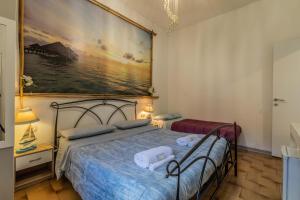a bedroom with two beds and a painting on the wall at Bed Rho Fiera - Milano Galeazzi in Rho
