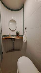 a bathroom with a white toilet and a mirror at Casa Campo Chiloé in Chonchi +6 photos