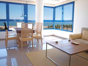 a living room with a table and a couch at ApartUP Patacona Panoramic in Valencia