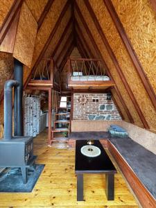 a room with a fireplace and a stove in a attic at Villa Alpi in Nižepole