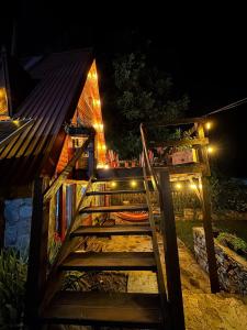 a wooden staircase leading to a house at night at Villa Alpi in Nižepole +27 photos