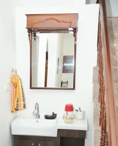 a bathroom with a sink and a mirror at White Haven in Angamaly +29 photos