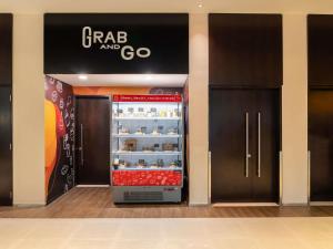 a candy store with a refrigerator in a mall at ibis Dubai One Central in Dubai