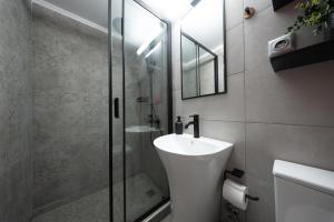 a bathroom with a sink and a glass shower at Oniro Living - Skra 10 in Mytilene +27 photos