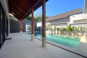 an external view of a house with a swimming pool at Bougainvillea Luxury Pool Villas in Ban Pak Lak