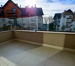 a balcony with a view of some buildings at Apartamento Loft Gramado in Gramado