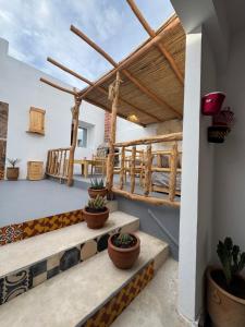 a patio with stairs and potted plants in a house at Atlantic refuge in Wassane