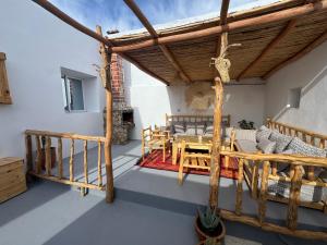 a patio with a wooden pergola and a table at Atlantic refuge in Wassane