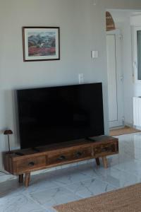 a large flat screen tv sitting on top of a wooden coffee table at Casa MaJa in Denia