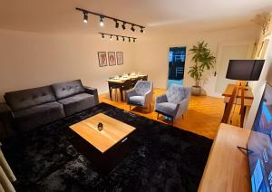 a living room with a couch and a table at Apartamento Major Nicoletti in Gramado