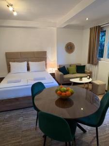 a bedroom with a bed and a table with a bowl of fruit on it at Apartments Bajkovic in Kotor