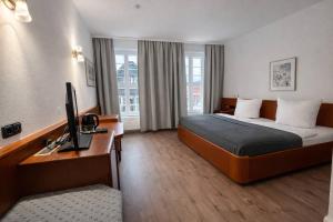 En eller flere senge i et værelse på Hotel Borchers