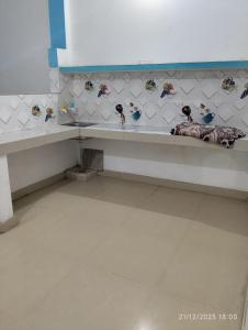 a room with a bench with birds on the wall at Shree Balaji home stay Ayodhya contact number 92782-97365 in Ayodhya