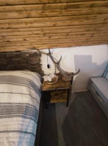 a bedroom with a bed and a table with a antelope on it at Menyecske Guesthouse in Keszü +60 photos