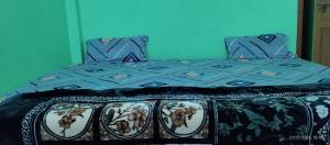 a bed with a blue comforter and pillows at Shree Balaji home stay Ayodhya contact number 92782-97365 in Ayodhya +17 photos