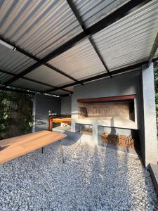 a patio with a wooden table and a fireplace at Chalet La Isolina in Villa Giardino
