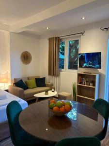 a living room with a table with a bowl of fruit on it at Apartments Bajkovic in Kotor
