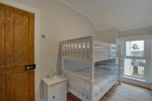a white bunk bed in a room with a window at 2 Bed in Mumbles oc-hh1201 in The Mumbles