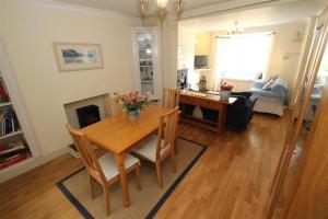 a living room with a wooden table and a dining room at 2 Bed in Mumbles oc-hh133 in The Mumbles +9 photos