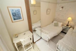 a small room with two beds and a mirror at 2 Bed in Mumbles oc-hh133 in The Mumbles