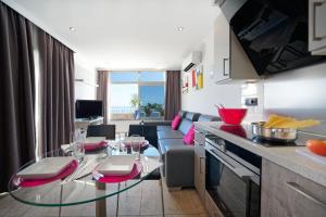 a living room with a couch and a glass table at Bahia Blanca in Puerto Rico de Gran Canaria