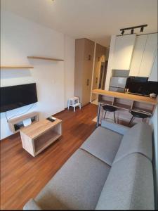 a living room with a couch and a table at Master Quart studio apartment in Podgorica