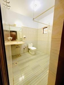 a bathroom with a toilet and a sink at Karachi Family Guest House in Karachi +40 photos