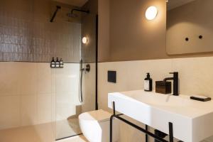 a bathroom with a sink and a toilet and a shower at Ikonik Marengo in Nice