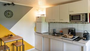 a kitchen with a refrigerator and a counter top at Bel La Vi Apartment in Le Lamentin