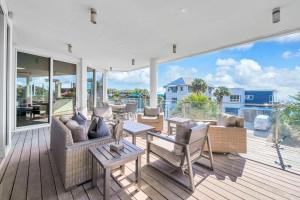 a living room with a deck with furniture and windows at Viridian 201 in Santa Rosa Beach