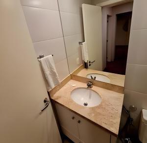 a bathroom with a sink and a mirror at Gramado Loft 105 in Gramado +17 photos