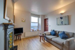 a living room with a couch and a fireplace at 1 Bed in Mumbles oc-hh1205 in The Mumbles