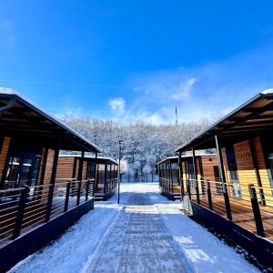 a couple of buildings with snow on the ground at B&B Snow Village Roccaraso in Roccaraso