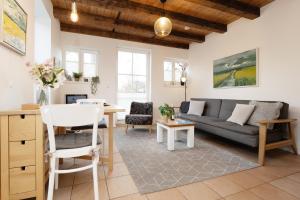 un soggiorno con un divano e un tavolo di Räucherhäuschen a Fehmarn