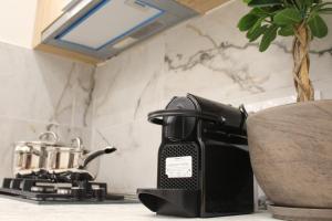 a coffee maker sitting on a counter in a kitchen at Lūma Retreat in Kastoria