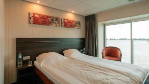 En eller flere senge i et værelse på Arielle Queen Flusskreuzfahrtschiff