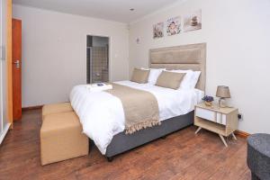 a bedroom with a large bed and a table at African Oasis Morrocco in Somerset West +31 photos