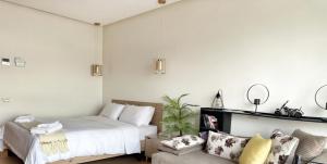 a bedroom with a bed and a couch at 3-marina Serena ocean-studio chic vue mer in Casablanca