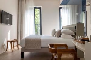 a bedroom with a large white bed and a desk at Ikonik Jean Médecin in Nice +37 photos