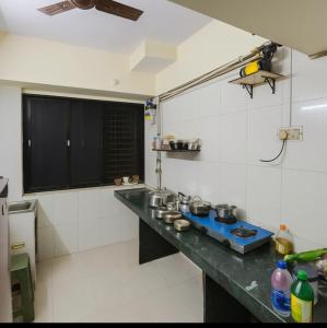 a kitchen with a counter with pots and pans on it at Luxurious Private Room in thane only for Male in Thane