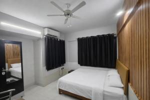 a bedroom with a bed and a ceiling fan at Luxurious Private Room in thane only for Male in Thane