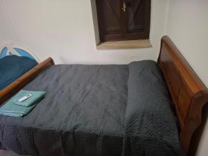 a bed with a wooden frame in a room at Simou Apartment in Simou