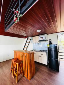 a kitchen with a wooden counter and a black refrigerator at Cabaña El Encanto in El Porvenir +9 photos