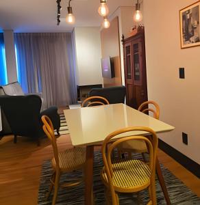 a living room with a table and chairs at Tribeca Gramado 12 in Gramado