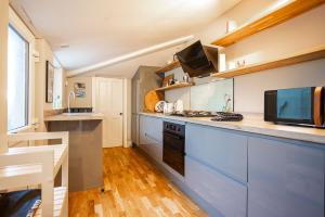 a kitchen with blue cabinets and a counter top at The Winkle - Elie in Elie