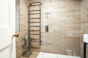 a bathroom with a shower with a toilet at The Winkle - Elie in Elie