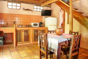 a kitchen with a table and a refrigerator at Apartamento Boruca Tamarindo in Tamarindo